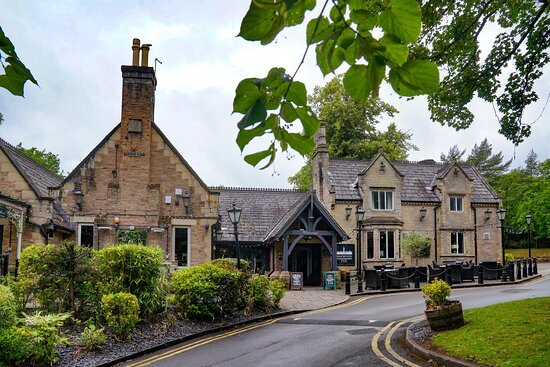 a building with a chimney and a street with trees john gilbert worsley